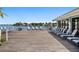 Waterfront deck featuring patio furniture and lounge chairs at 9415 Blind Pass Rd # 905, St Pete Beach, FL 33706