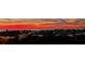 Colorful sunset casts warm hues over this vibrant community and waterfront with passing traffic on the bridge at 9415 Blind Pass Rd # 905, St Pete Beach, FL 33706