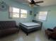 Cozy bedroom with a bed and two armchairs at 223 94Th Ne Ave, St Petersburg, FL 33702