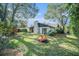 Spacious backyard with fire pit and mature trees at 2383 Indian E Trl, Palm Harbor, FL 34683