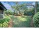 Large backyard with playset and lush landscaping at 2383 Indian E Trl, Palm Harbor, FL 34683