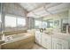 Updated bathroom with a bathtub and marble tile at 2383 Indian E Trl, Palm Harbor, FL 34683