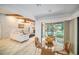Bright dining area with glass table and view to backyard at 2383 Indian E Trl, Palm Harbor, FL 34683