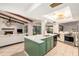 Open concept kitchen with island, exposed beams, and fireplace view at 2383 Indian E Trl, Palm Harbor, FL 34683