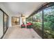 Relaxing screened porch with seating and backyard access at 2383 Indian E Trl, Palm Harbor, FL 34683