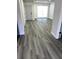 Light and airy entryway featuring gray vinyl flooring and a modern door at 7222 Riverwood Blvd, Tampa, FL 33615