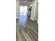 Clean and bright hallway with vinyl flooring and view to backyard at 7222 Riverwood Blvd, Tampa, FL 33615