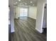 Bright living room with gray vinyl flooring and recessed lighting at 7222 Riverwood Blvd, Tampa, FL 33615
