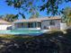 Home features a refreshing pool with a screened patio at 7222 Riverwood Blvd, Tampa, FL 33615
