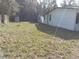 Large backyard with shed and grassy area at 10040 Jungle St, New Port Richey, FL 34654