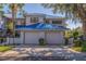 Beautiful townhome showcasing a sleek blue metal roof, lovely landscaping, and private two-car garage at 1688 Watermark Ne Cir # 1688, St Petersburg, FL 33702