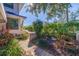 Paver walkway leading to the home highlighting the tropical landscaping and greenery at 1688 Watermark Ne Cir # 1688, St Petersburg, FL 33702