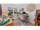 Cozy office space with natural light, hardwood floors, and a view of the outdoors, creating a serene workspace at 1688 Watermark Ne Cir # 1688, St Petersburg, FL 33702