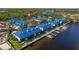 Beautiful waterfront condo complex featuring private boat docks, manicured lawns, and vibrant blue roofs at 1688 Watermark Ne Cir # 1688, St Petersburg, FL 33702
