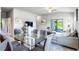Open concept dining area with glass table and grey cushioned chairs at 174 Green Oak Park, Rotonda West, FL 33947