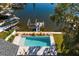 Elevated view of refreshing pool, private dock, and lush landscaping at 5104 Homer W Ave, Tampa, FL 33629