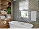 Relaxing bathroom with a freestanding tub and built-in shelving at 5104 Homer W Ave, Tampa, FL 33629