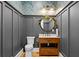 Powder room with wood vanity and floral wallpaper at 5104 Homer W Ave, Tampa, FL 33629