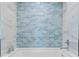 Bathroom with light blue tile and a modern soaking tub at 5104 Homer W Ave, Tampa, FL 33629