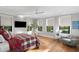 Spacious bedroom with hardwood floors, large windows, and a comfy sitting area at 5104 Homer W Ave, Tampa, FL 33629