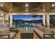 Covered patio with fire pit and waterfront views at night at 5104 Homer W Ave, Tampa, FL 33629