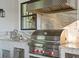 Outdoor kitchen features stainless steel grill and marble countertop at 5104 Homer W Ave, Tampa, FL 33629