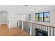 Bright landing with hardwood floors, a stylish chandelier, and a modern staircase at 5104 Homer W Ave, Tampa, FL 33629