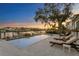 Inviting pool and patio area with lounge chairs, offering serene waterfront views at sunset at 5104 Homer W Ave, Tampa, FL 33629