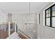 Modern staircase with a large globe chandelier at 5104 Homer W Ave, Tampa, FL 33629