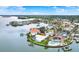 Expansive aerial view of waterfront homes showcasing luxurious living with docks and lush landscaping at 5631 Bayview Dr, Seminole, FL 33772