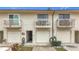 Tan three-unit building with attached garages and private balconies at 6262 93Rd N Ter # 3904, Pinellas Park, FL 33782