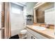 Bathroom with a shower-tub combination, single sink vanity, and a wood-look accent wall at 11402 Coventry Grove Cir, Lithia, FL 33547