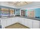 Well-equipped community kitchen with white cabinets and a view of the pool at 2489 Oakleaf Ln # 21C, Clearwater, FL 33763