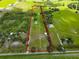 Aerial view of property highlighting expansive land and buildings at 19212 Grange Hall Loop, Wimauma, FL 33598