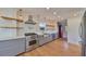 Modern kitchen with stainless steel appliances and white cabinets at 19212 Grange Hall Loop, Wimauma, FL 33598