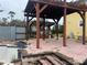 Brick patio area with wooden pergola structure at 19212 Grange Hall Loop, Wimauma, FL 33598