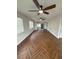 Living room with herringbone floors and ceiling fans at 1006 N Bask Dr, Tampa, FL 33603