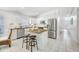 Modern kitchen featuring granite island, stainless steel appliances, and white cabinetry at 11917 Spindrift Loop, Hudson, FL 34667