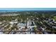 Aerial view of a residential complex nestled in a quiet neighborhood with water views in the distance at 1221 Drew St # E11, Clearwater, FL 33755