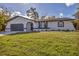 Modern home with a dark gray garage and white exterior at 4290 Yucatan Cir, Port Charlotte, FL 33948