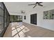 Spacious screened porch with wood-look flooring and ceiling fans at 4290 Yucatan Cir, Port Charlotte, FL 33948