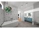 Elegant bathroom with soaking tub, double vanity, and geometric tile at 275 44Th Ave, St Pete Beach, FL 33706