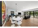 Modern dining room with white table and chairs, hardwood floors at 275 44Th Ave, St Pete Beach, FL 33706