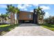 Modern home exterior with a paved driveway and tropical landscaping at 275 44Th Ave, St Pete Beach, FL 33706