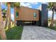 Modern home exterior with wood and dark-colored siding, showcasing a sleek and stylish design at 275 44Th Ave, St Pete Beach, FL 33706