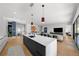 Open concept kitchen with island and breakfast bar, looking towards living room at 275 44Th Ave, St Pete Beach, FL 33706