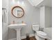 Stylish bathroom with pedestal sink and hardwood floors at 290 Valencia Cir, St Petersburg, FL 33716