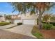 Tan two-story townhome with attached garage and landscaping at 290 Valencia Cir, St Petersburg, FL 33716