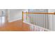 Light-filled hallway with wood flooring and elegant staircase at 290 Valencia Cir, St Petersburg, FL 33716