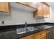 Modern kitchen with stainless steel sink and wood cabinets at 290 Valencia Cir, St Petersburg, FL 33716